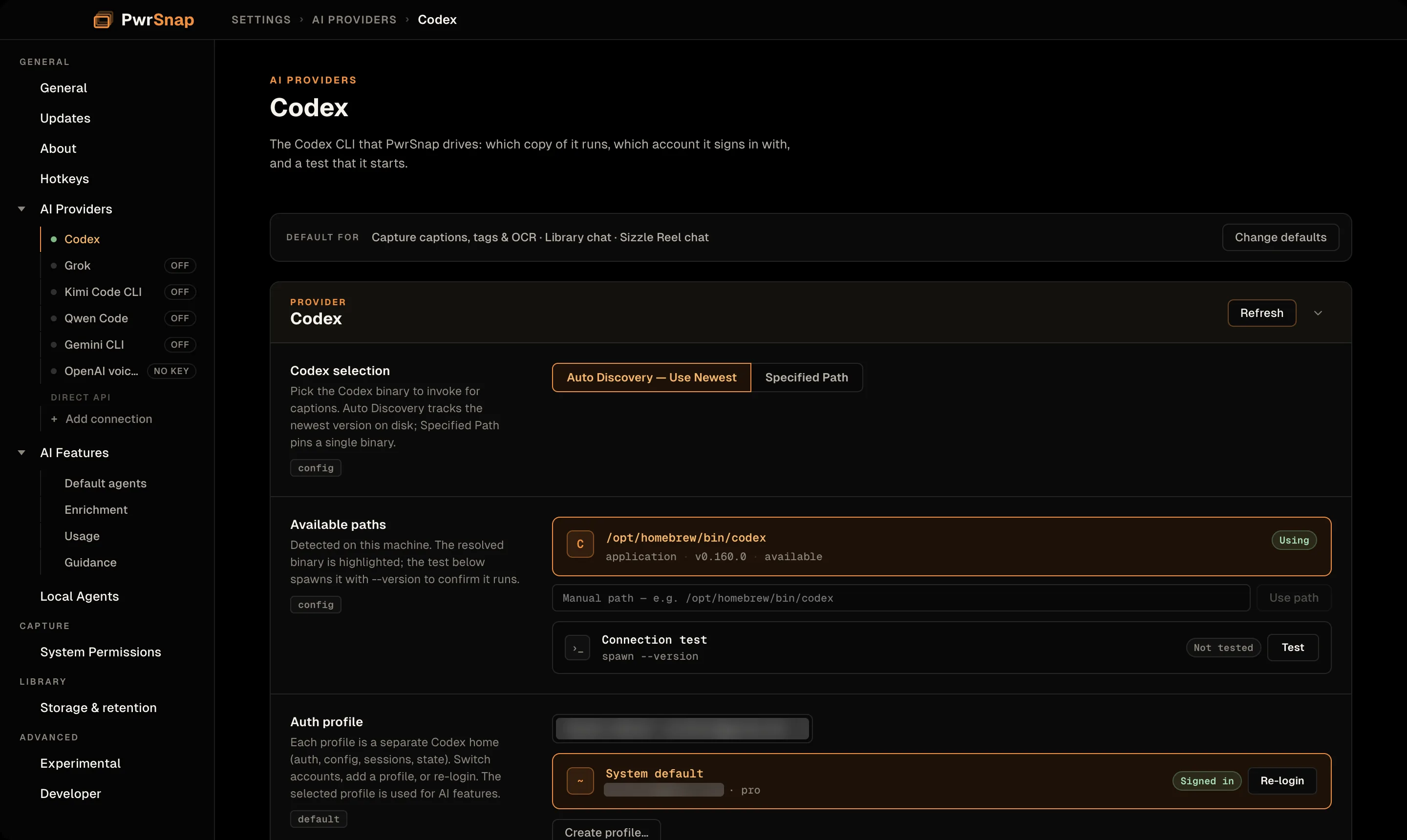 The AI Providers, Codex page. A strip at the top reads Default for: Capture captions, tags and OCR, Library chat, and Sizzle Reel chat, with a Change defaults button. The Codex card has a Codex selection control with Auto Discovery and Specified Path; an Available paths list showing /opt/homebrew/bin/codex at version 0.160.0 marked Using; a manual path field; a connection test row; and an Auth profile row with the account name blurred, marked Signed in, with Re-login and Create profile buttons.