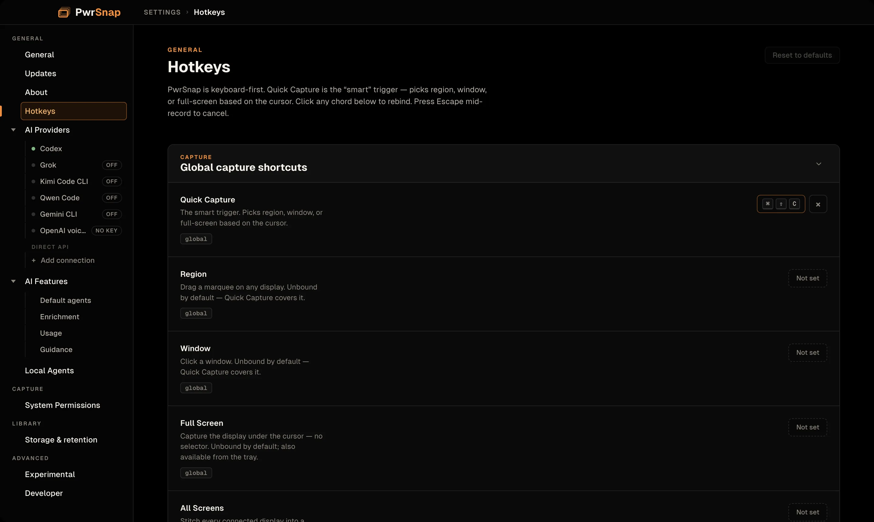 The Hotkeys page in PwrSnap Settings. The sidebar shows the General group with General, Updates, About, Hotkeys (selected), AI Providers expanded to Codex, Grok, Kimi Code CLI, Qwen Code, Gemini CLI, and OpenAI voiceover, the ACP agents each marked OFF and OpenAI marked NO KEY, then a Direct API heading with Add connection; AI Features expanded to Default agents, Enrichment, Usage, and Guidance; and Local Agents. Below come System Permissions under Capture, Storage & retention under Library, and Experimental and Developer under Advanced. The page intro reads: PwrSnap is keyboard-first. Quick Capture is the smart trigger, picking region, window, or full-screen based on the cursor. Click any chord below to rebind. Press Escape mid-record to cancel. Reset to defaults is dimmed at the top right. In the Global capture shortcuts card, Quick Capture is bound to Command+Shift+C with a clear button beside it; Region, Window, Full Screen, and All Screens each read Not set.